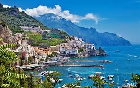 Woman in a sunhat on a classic wooden boat on the Amalfi Coast, Italy